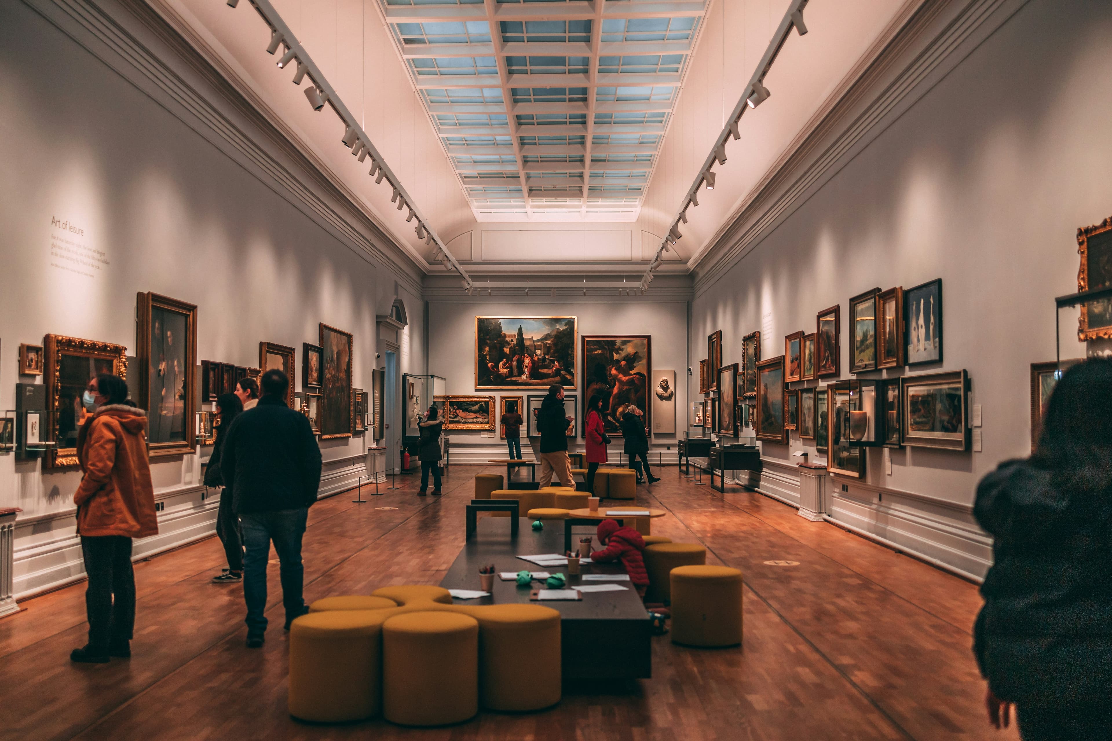 Art in Sydney: gallery visitors viewing paintings in a classical exhibition hall