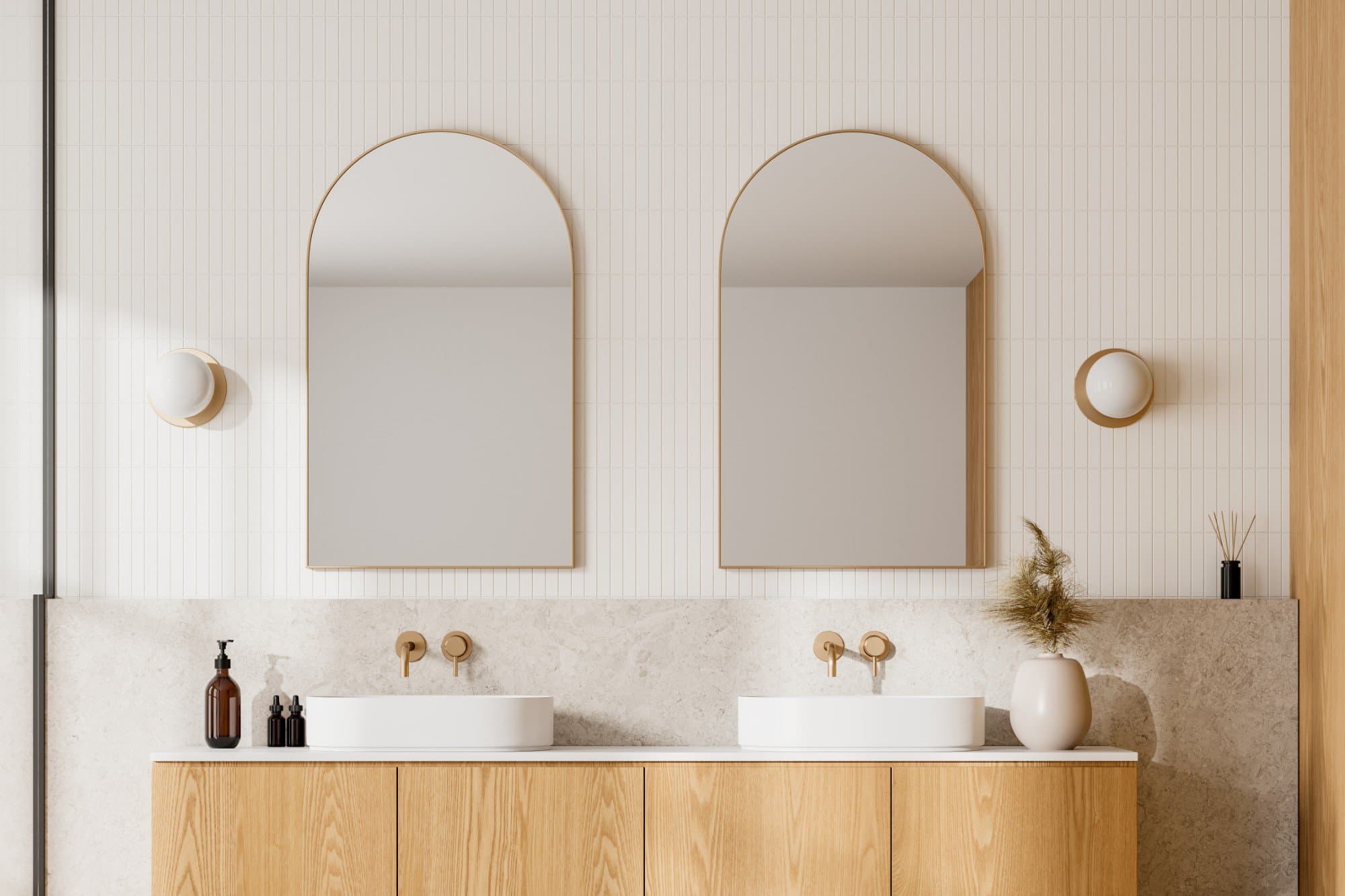 Interior design Sydney: bathroom with twin arched brass mirrors, a fluted oak vanity and a stone benchtop